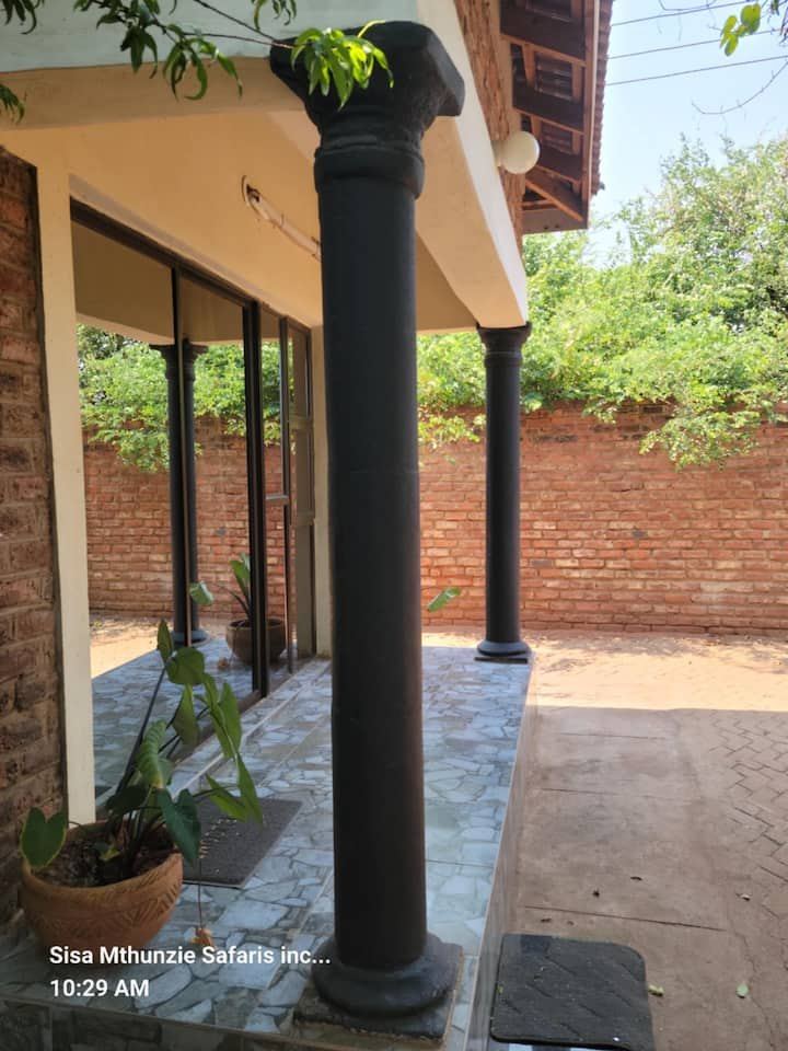 Shaded verandah and garden at Granadilla Cottage in Aerodrome, Victoria Falls