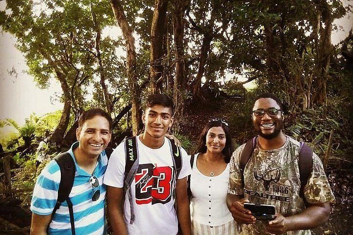 Guides and guests on a rainforest path beside Victoria Falls
