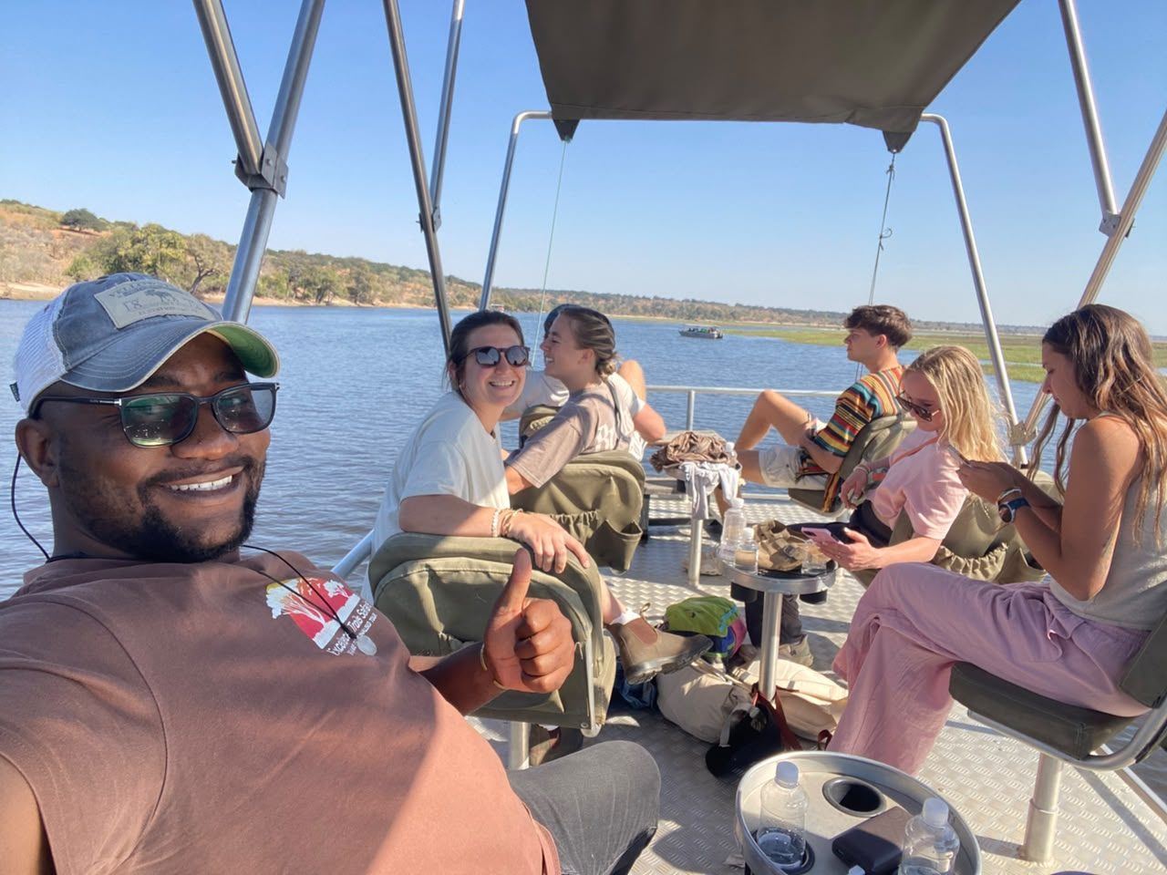 Guests relaxing on a Chobe River boat cruise with their guide
