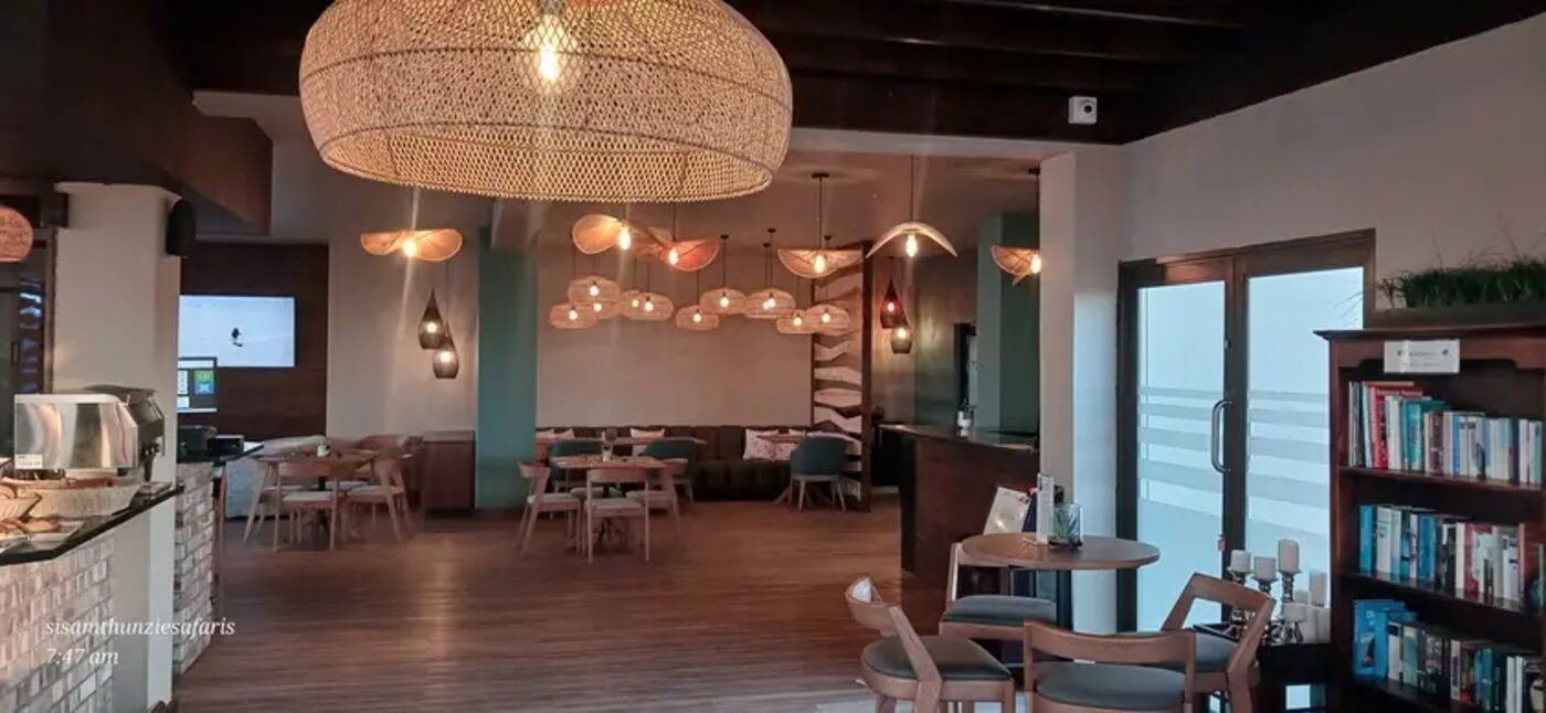 Lodge lounge with woven basket light fixtures and wooden furniture